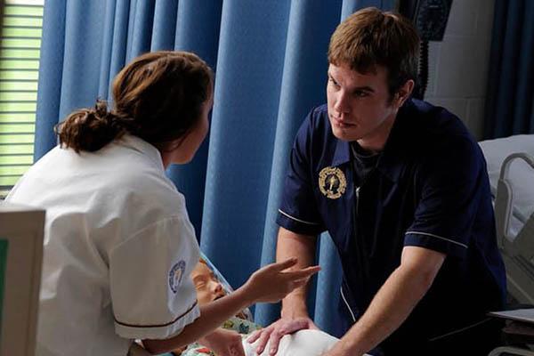 Two nursing students working together to take care of a practice patient